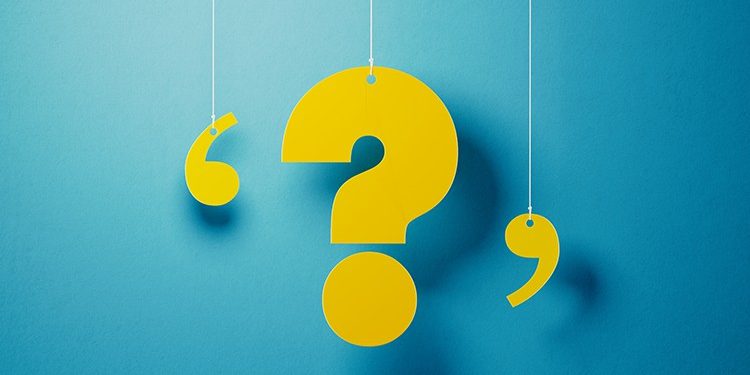 Yellow question mark with string hanging over blue background. Horizontal composition with copy space.